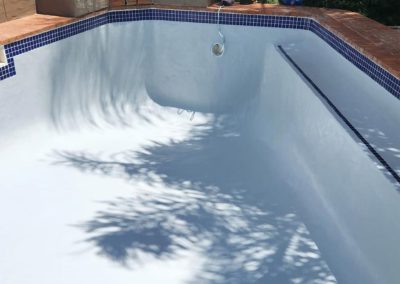 Finished concrete pool with white interior.