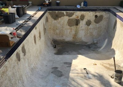Concrete swimming pool undergoing renovations.